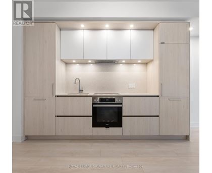 A modern kitchen with wooden cabinets and stainless steel appliances.