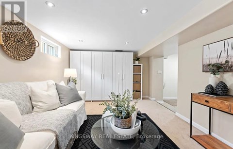 A modern living room with a white sofa and a wooden coffee table.