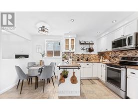 A kitchen with a table and chairs in the middle of the room.