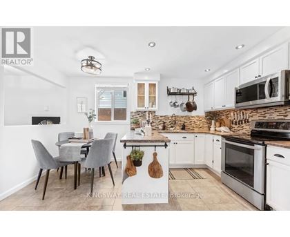 A kitchen with a table and chairs in the middle of the room.
