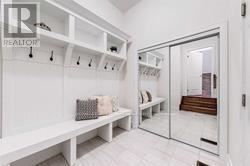 A white bench with storage space is in the image.