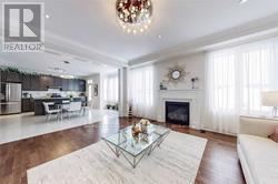 A living room with a white couch and a glass coffee table.