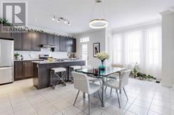 A modern kitchen with a dining table set for two.
