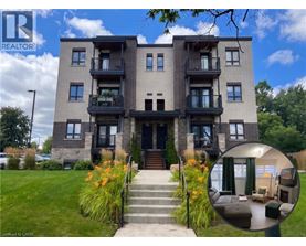 A modern apartment building with a realtor logo and a photo of the interior of one of the units.