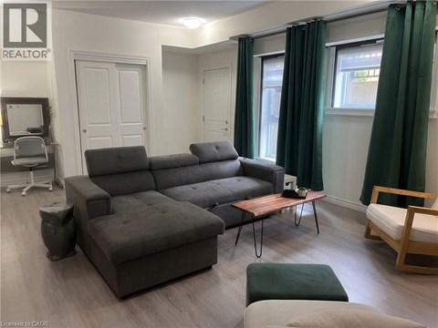 A grey sofa in a living room with a wooden coffee table.