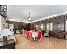A dining room with a long table set for a meal.