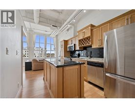 A modern kitchen with wooden cabinets and stainless steel appliances.