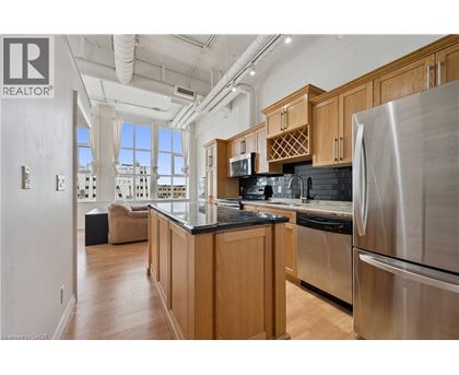 A modern kitchen with wooden cabinets and stainless steel appliances.