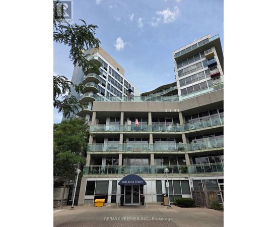A large building with a balcony and a blue awning that says 1600 Kelley Street.