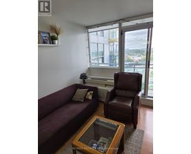A living room with a couch, chair, and coffee table.