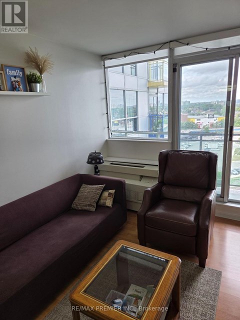 A living room with a couch, chair, and coffee table.