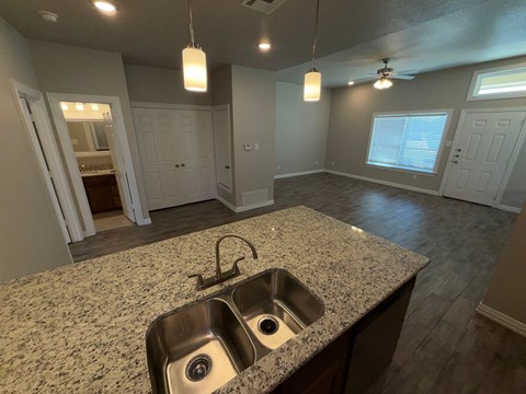 A kitchen with granite countertops and a sink.