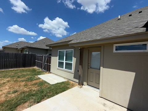 A house with a brown roof and a grey door.