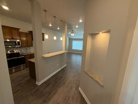 A kitchen with wooden cabinets and a countertop.