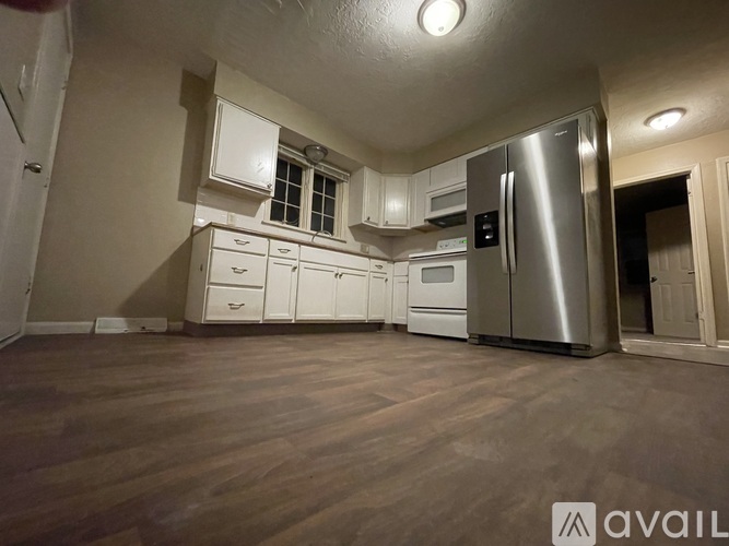 A kitchen with wooden floors and stainless steel appliances.