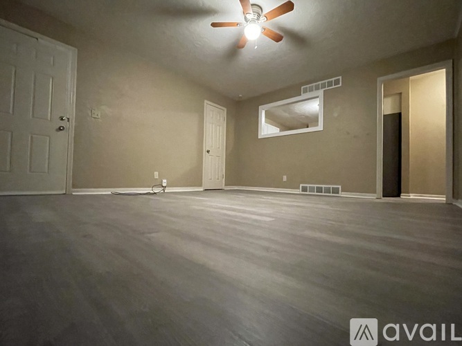 A room with a ceiling fan and a window.