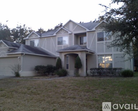 A house with a brown roof and a white garage door.