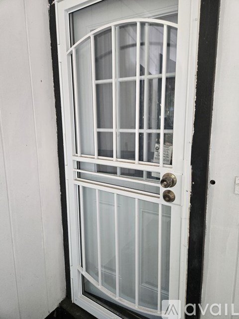 A white door with a glass panel and a handle.