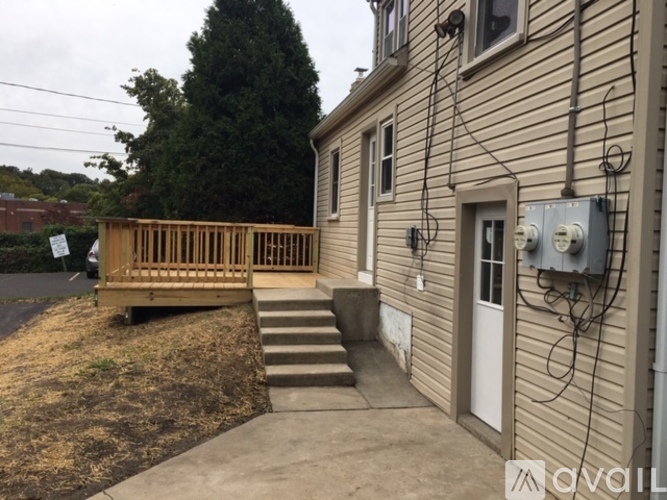 A house with a white door and a wooden deck.