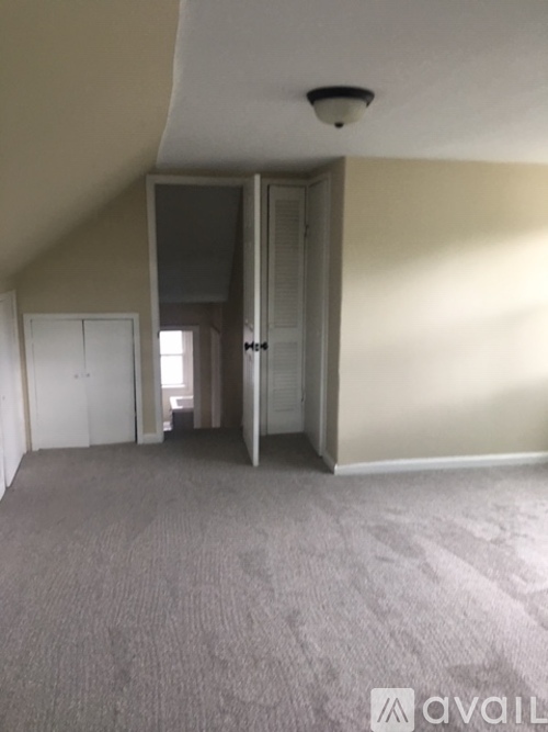 A room with a carpeted floor and a ceiling light.