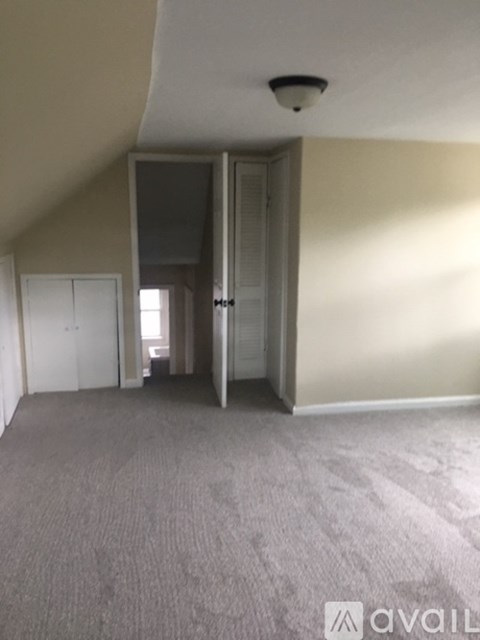 A room with a carpeted floor and a ceiling light.