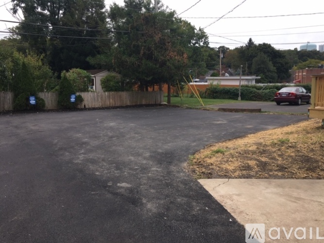 A parking lot with a car parked in the background.