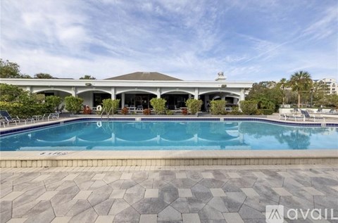 A large outdoor swimming pool with a building in the background.