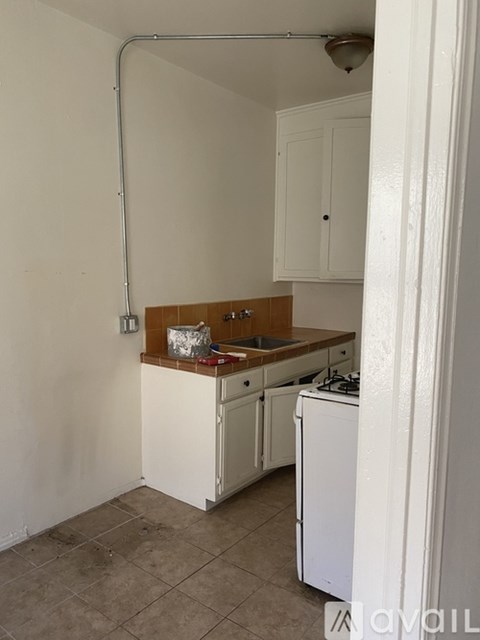 A kitchen with white cabinets and a white dishwasher.