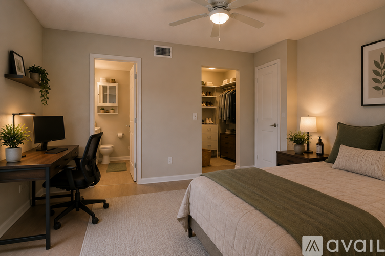 A bedroom with a bed, desk, and chair.