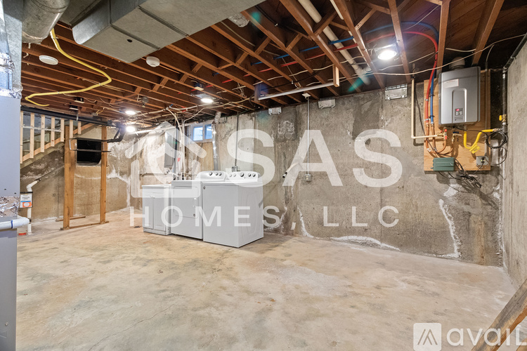 A room under construction with a wall that says "CASA HOMES LLC".