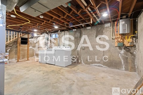 A room under construction with a wall that says "CASA HOMES LLC".