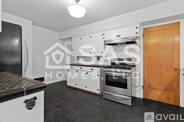 A modern kitchen with a stove, oven, and refrigerator.