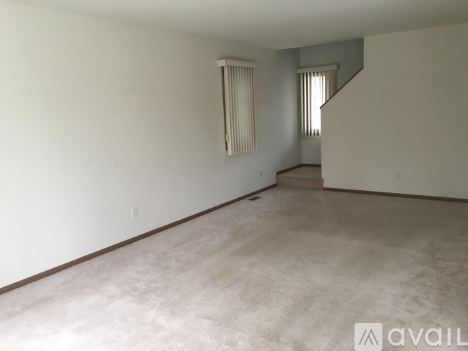 Empty room with a staircase on the right side.