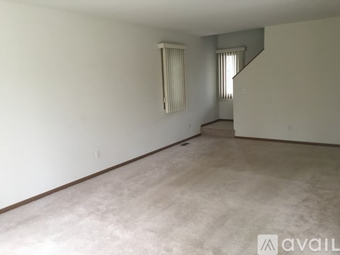 Empty room with a staircase on the right side.