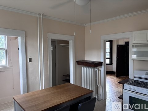 A kitchen with a wooden table and a white oven.