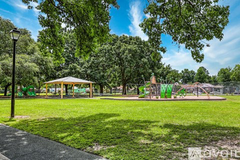 A park with a playground and a gazebo.