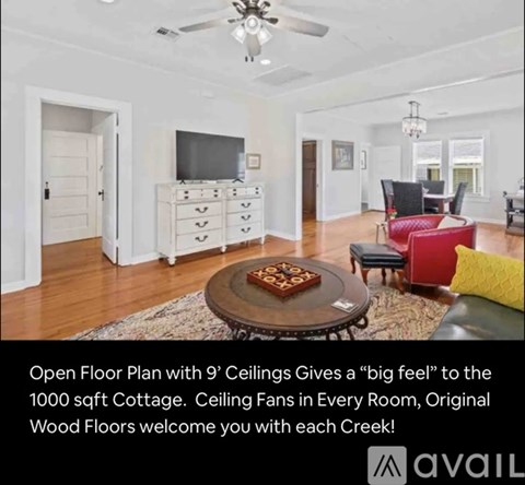 A living room with a ceiling fan and a coffee table with a book on it.