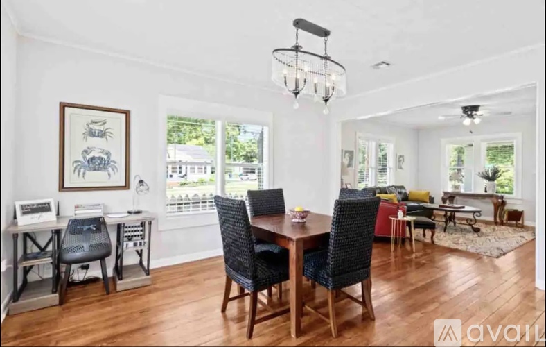 A dining room with a wooden table and chairs.