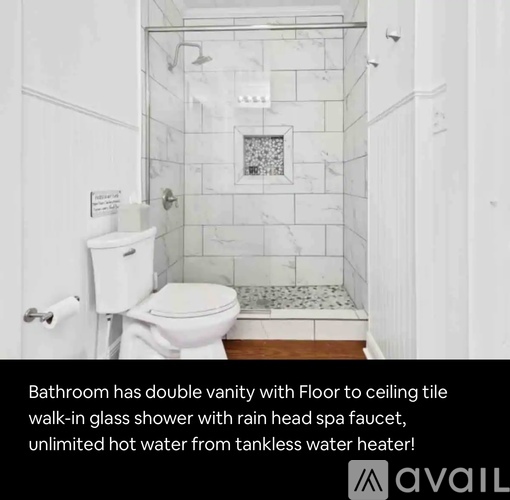 A bathroom with a white toilet, a walk-in glass shower, and a rain head spa faucet.