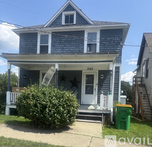 A blue house with the number 260 on the front door.