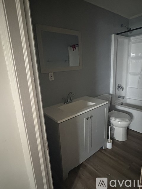 A bathroom with a toilet, sink, and bathtub.