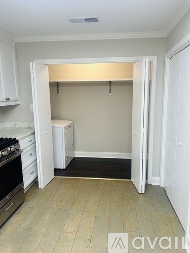 A kitchen with white cabinets and a black stove top oven.