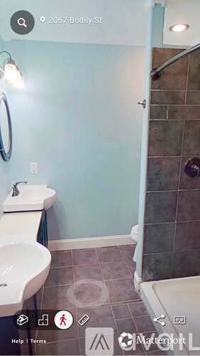 A bathroom with a sink, toilet, and a shower.