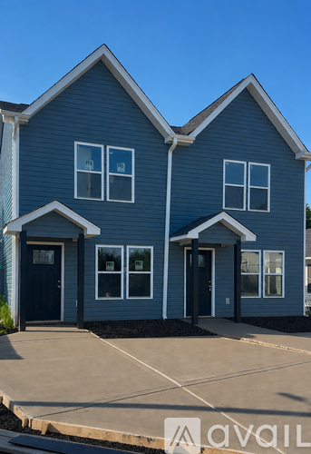 A blue house with a black door and windows.