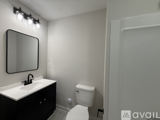 A white toilet sits next to a sink in a bathroom.