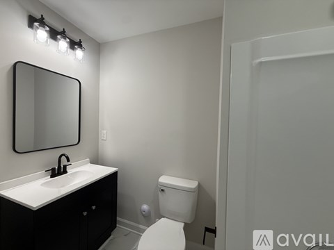 A white toilet sits next to a sink in a bathroom.