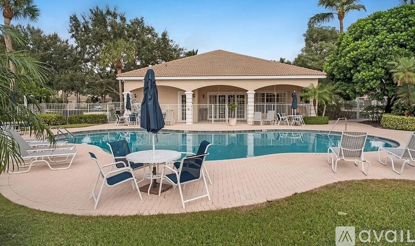 A house with a pool and patio furniture.