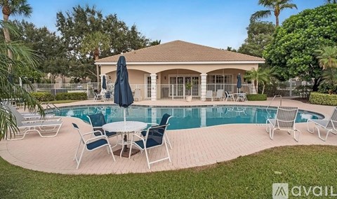 A house with a pool and patio furniture.