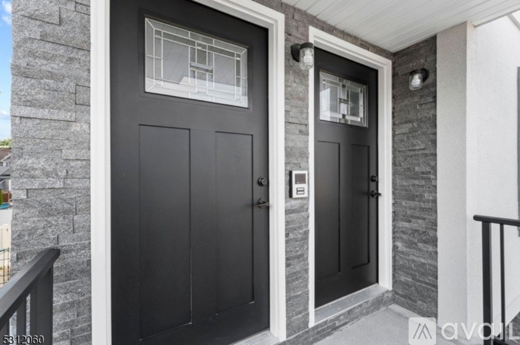 A black door with a glass window above it.