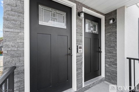 A black door with a glass window above it.